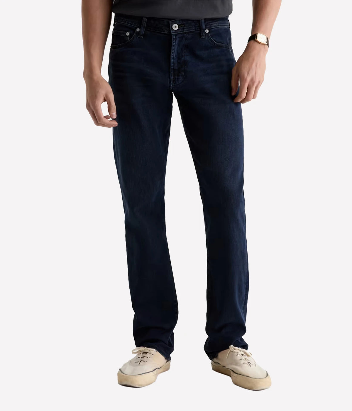Man wearing AG Graduate Jean in Studio with a charcoal tee and cream sneakers, front view