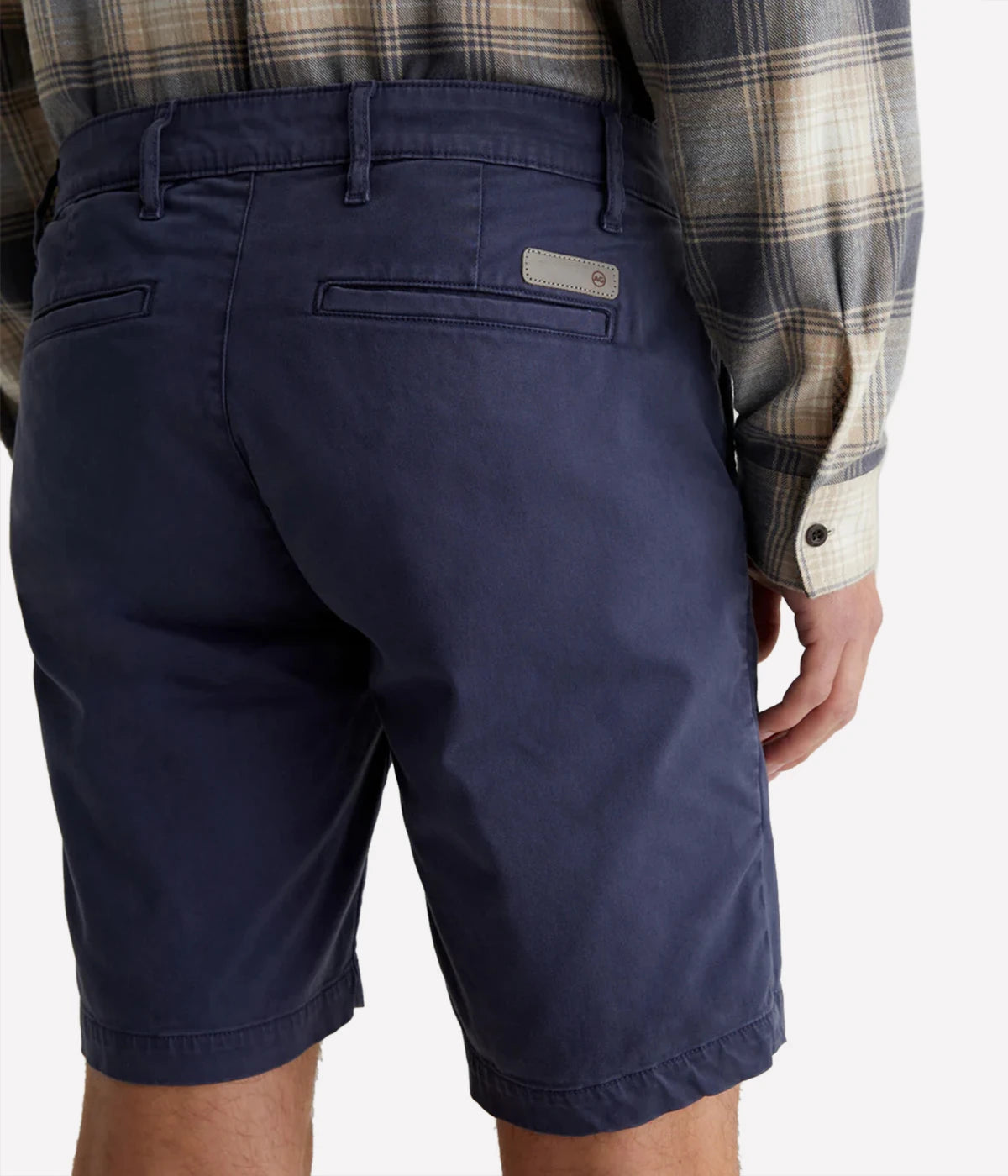 AG Wanderer Slim Fit Shorts in Sulfur Pacific Midnight (navy), featuring a sharp trouser look with a tapered leg opening. Made from ultra-lightweight cotton blend fabric for comfort. Material: 97.5% Cotton, 2.5% Elastane. Made in USA.