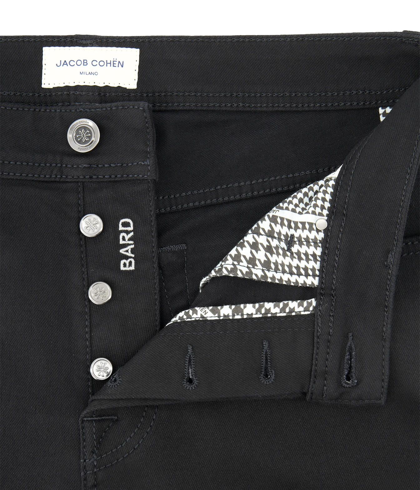 Close-up of black jeans by Jacob Cohen, showing the waistband, button closure, side pocket with 'BARD' embroidery, and a patterned inner lining.