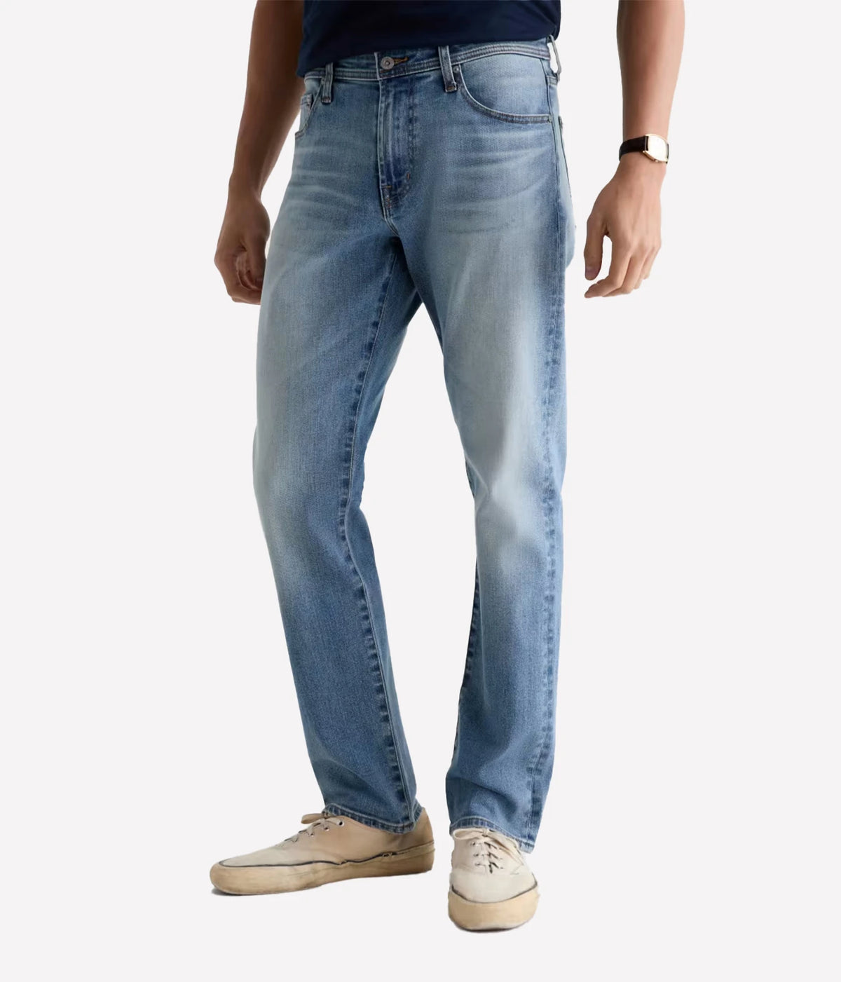 Man wearing AG Everett Jean in Watkins with a navy T-shirt and off-white sneakers, front view