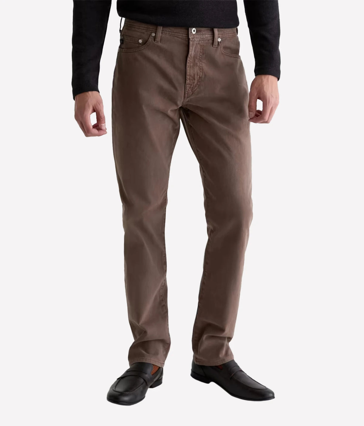 Man wearing AG Everett SUD Pant in Sulfur Taupe Grey with a black long-sleeve top and black shoes, front view