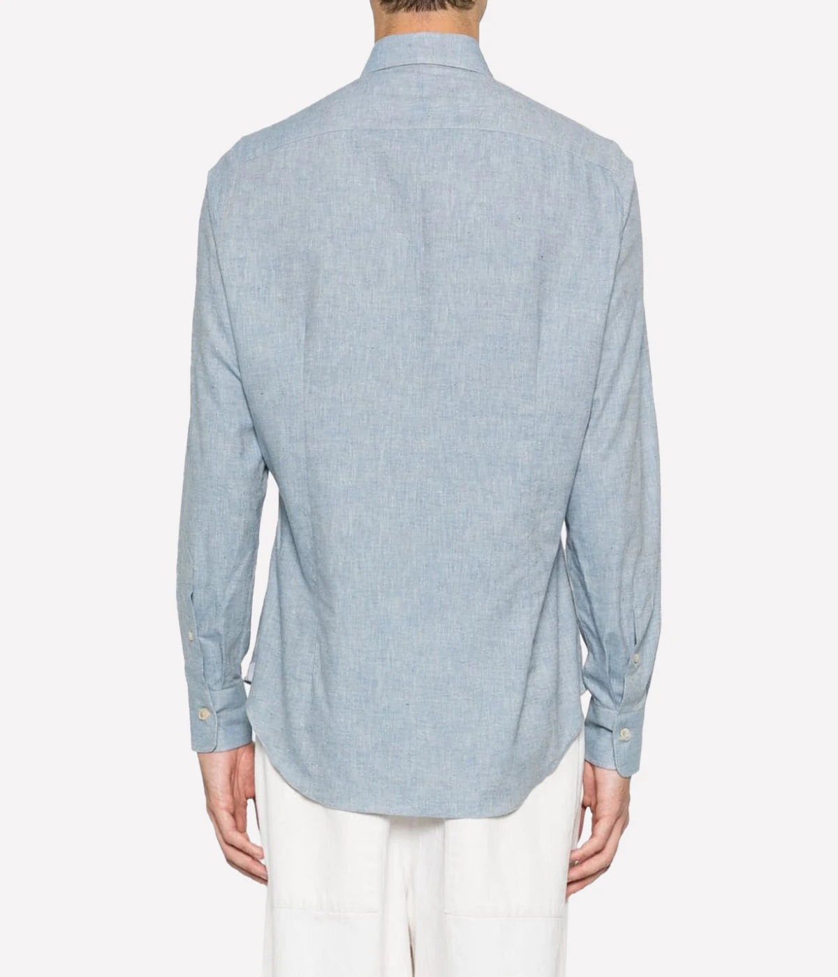 Dandy Shirt featuring a cutaway collar, front button fastening, and long sleeves with buttoned cuffs. Designed with a rear curved hem, this 100% cotton shirt blends refined style with relaxed elegance, perfect for smart-casual wear.