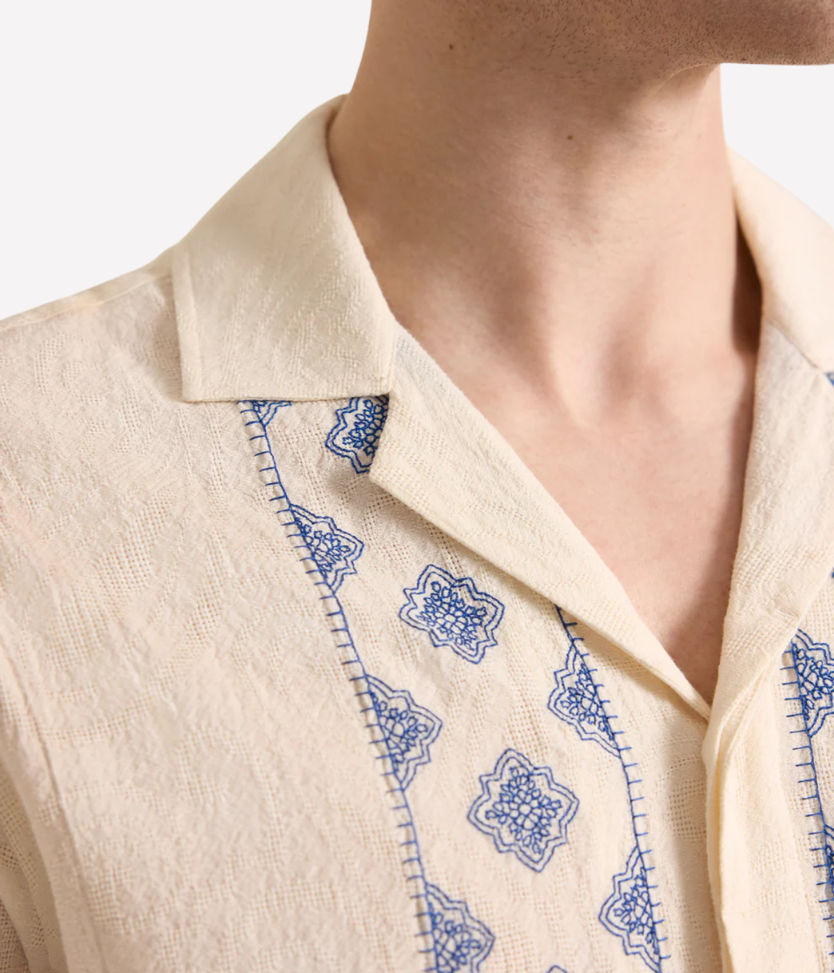 Orlebar Brown Maitan Carnival Embroidery Shirt in White Sand & Nightfall Blue featuring exclusive embroidered artwork, a Capri collar and relaxed fit - Closeup Shot on Collar