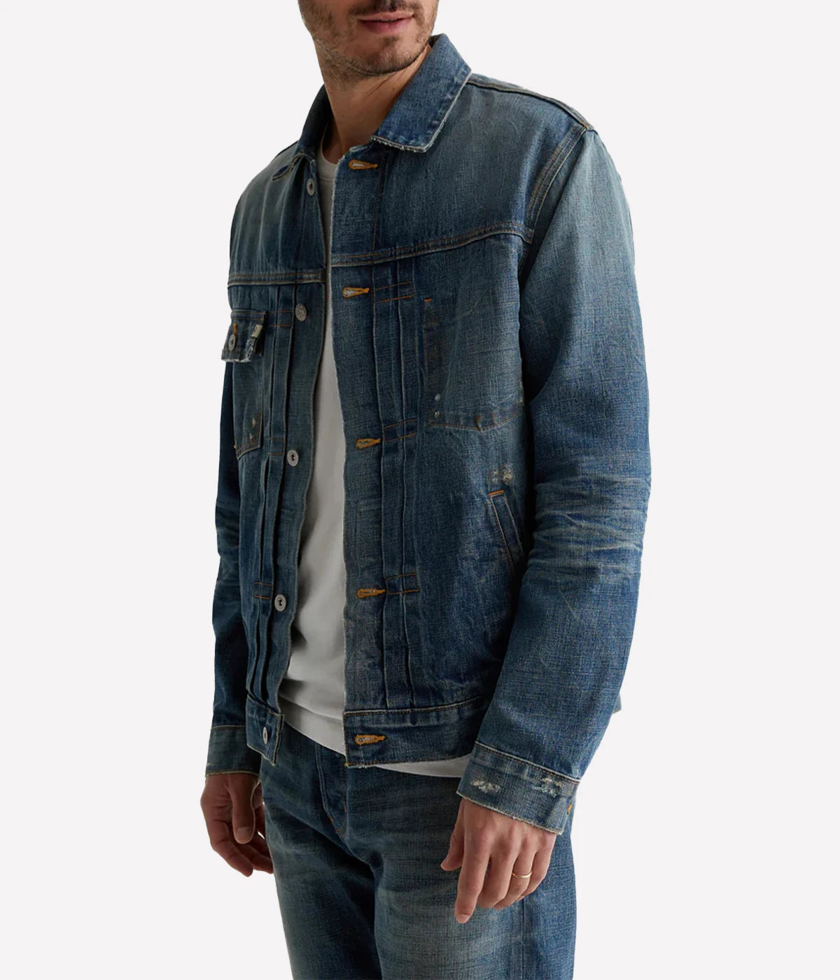 Classic trucker jacket made from premium Japanese selvage denim, featuring pleated front detailing and an authentic vintage wash with subtle distressing. Adjustable back tabs for a custom fit. Material: 100% Cotton. Made in USA.