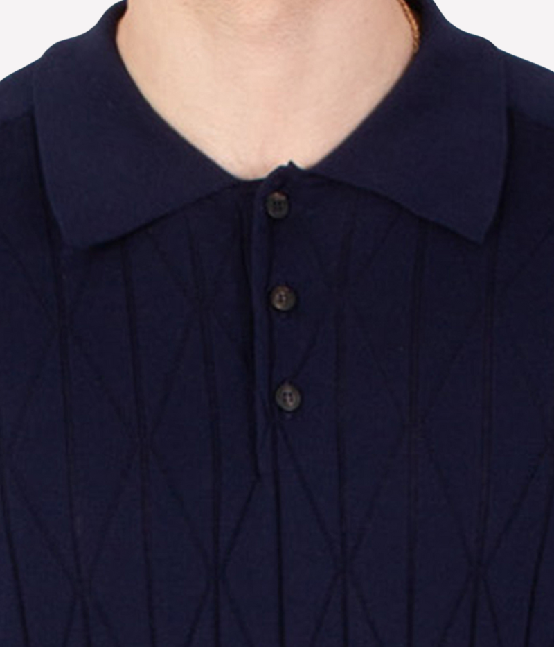 Navy pointelle-knit polo shirt with button placket, short sleeves, and ribbed trims, crafted from breathable cotton.