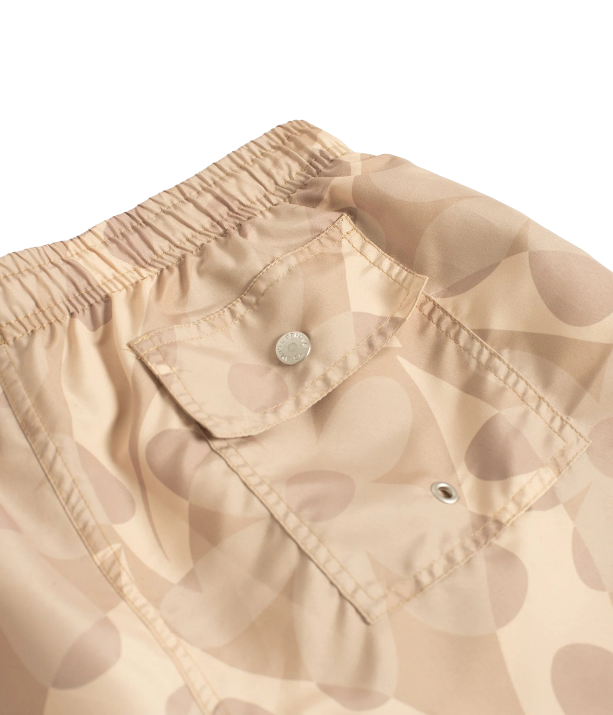 Close-up of snap-closure rear pocket on Bather Birch Daisy Trip Swim Trunk in Natural