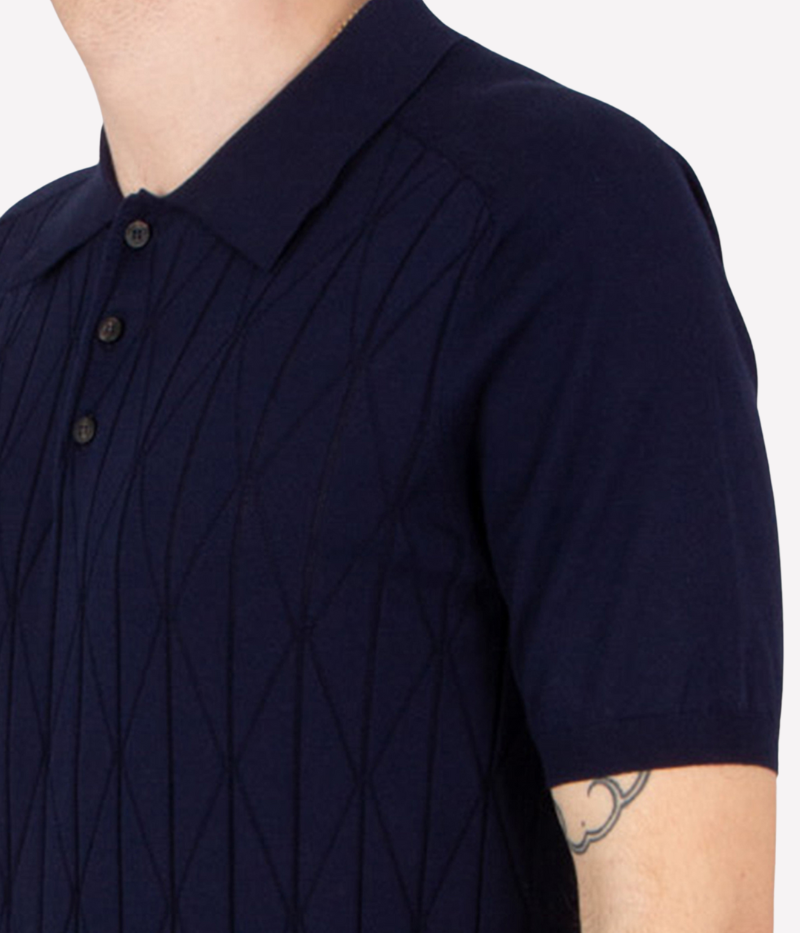 Navy pointelle-knit polo shirt with button placket, short sleeves, and ribbed trims, crafted from breathable cotton.