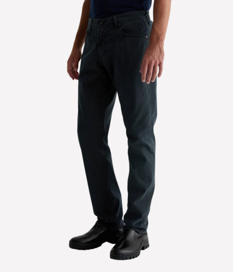 AG's Everett slim-straight men's pants in dark grey, crafted from 8.4 oz. Sueded Stretch Sateen from Italy. Featuring a mid-rise waist and a straight fit relaxed from hip to knee with a slight taper at the leg opening. Detailed measurements include a 10 1/4" front rise, 16 1/2" knee opening, 15" bottom opening, and 34" inseam.