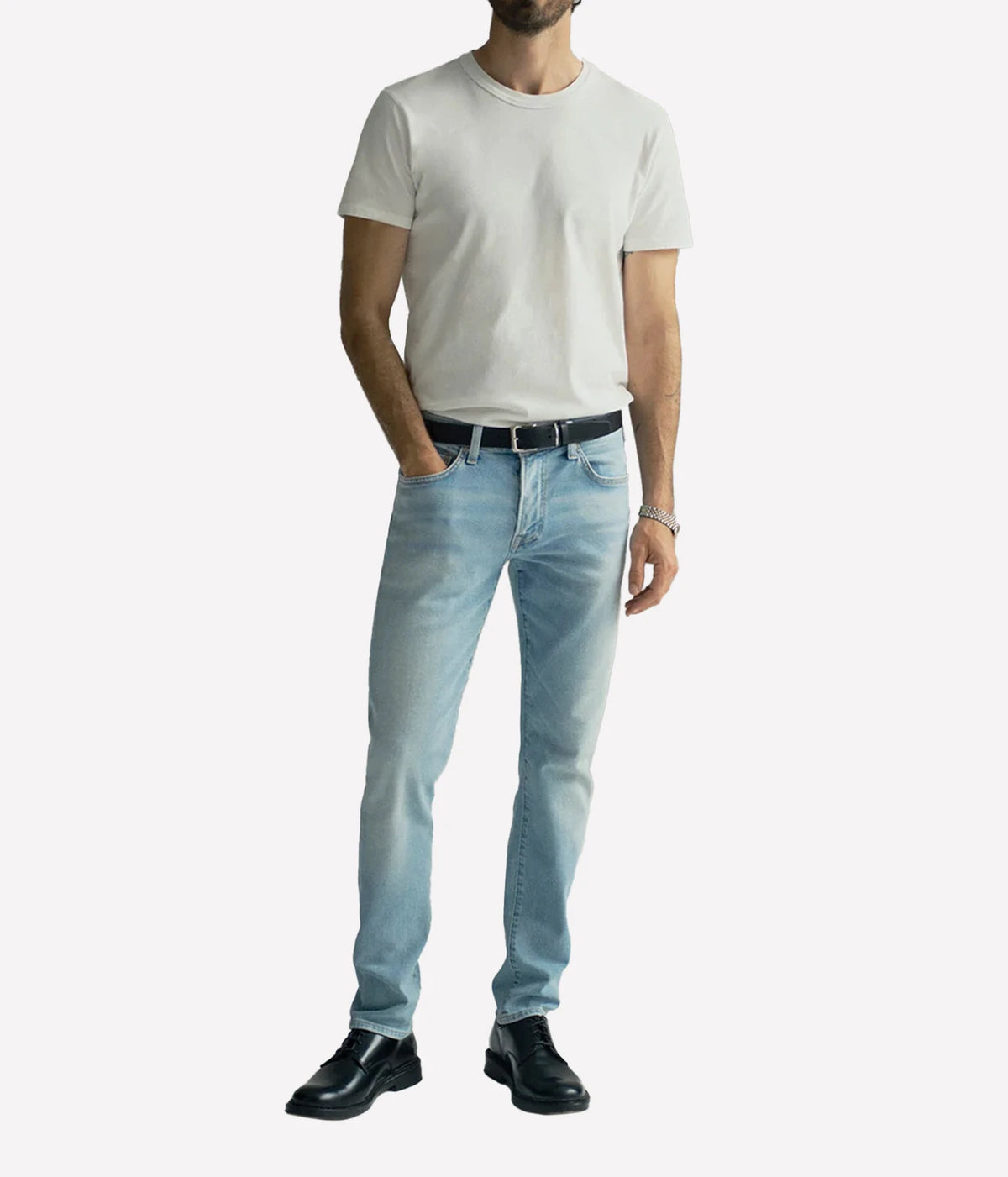 Man wearing Citizens of Humanity London Tapered Slim Perform Jean in Light Wash with a beige T-shirt, full-length front view