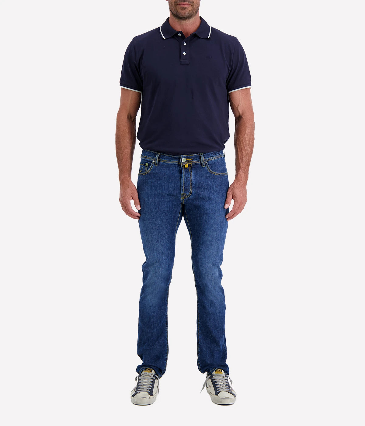 Close-up of the Bard 5-Pocket Jeans in dark blue stonewashed stretch denim, featuring a regular-slim fit. Crafted from a cotton-linen blend for comfort and durability, these jeans include an embroidered logo on the fifth pocket, a World print bandana, and a spool of thread. Finished with Jacob Cohën’s signature fragrance. Made in Italy.