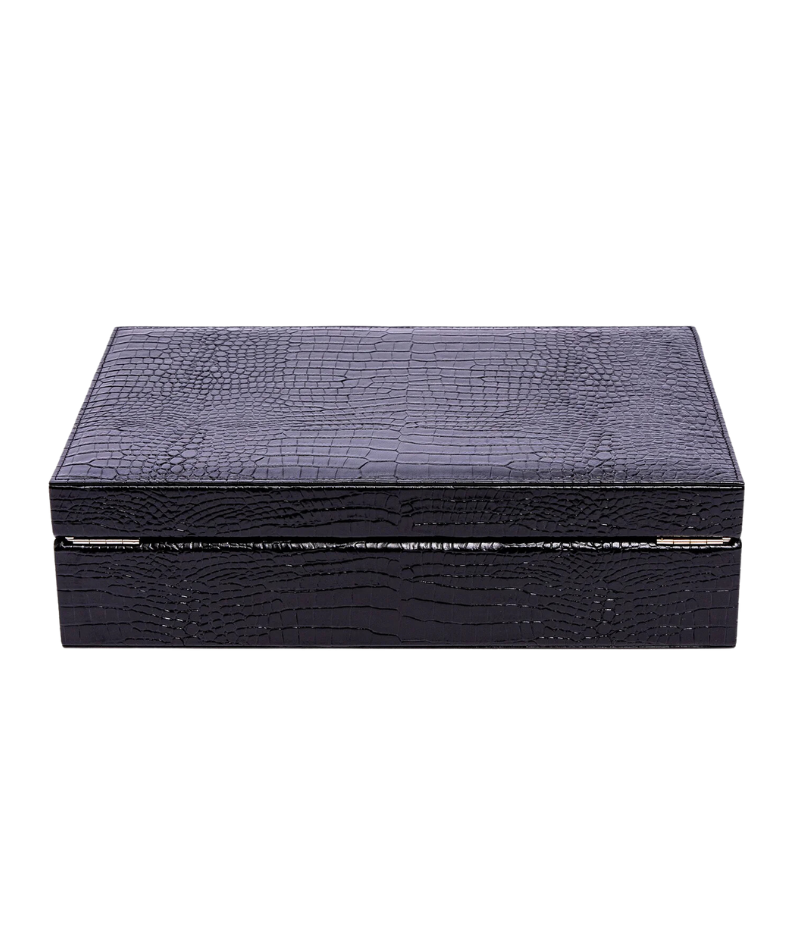 The Brompton Watch Box is meticulously handcrafted from solid wood and wrapped in luxurious black crocodile-pattern leather. Designed to hold up to ten watches, it features a plush suede-lined interior and adjustable cushions to securely fit timepieces of all sizes. A sophisticated storage solution for protecting and displaying your watch collection.