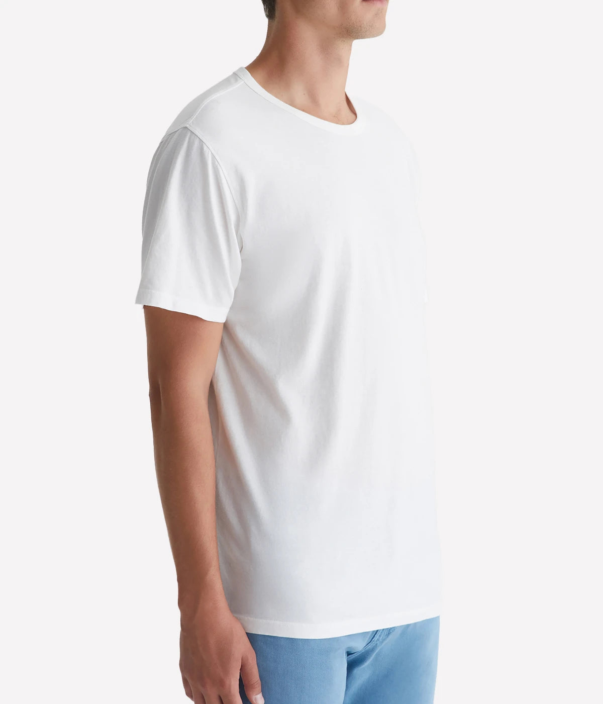 A model wearing the AG Bryce Crew Neck T-Shirt in pearl white, featuring short sleeves and a classic crew neck design, made from 100% cotton for a soft and relaxed fit.