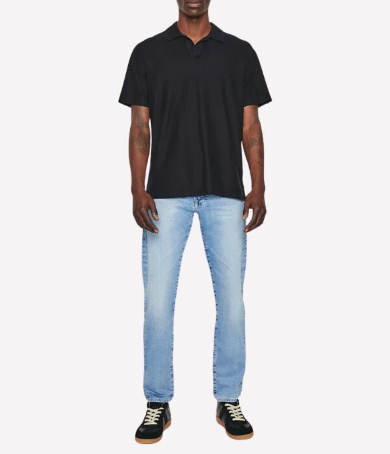 Model wearing the AG Bryce Johnny Collar Polo Shirt, featuring a pointed collar, relaxed neckline, and short sleeves. The textured lightweight terry fabric offers softness and dimension for a summery yet cozy look.