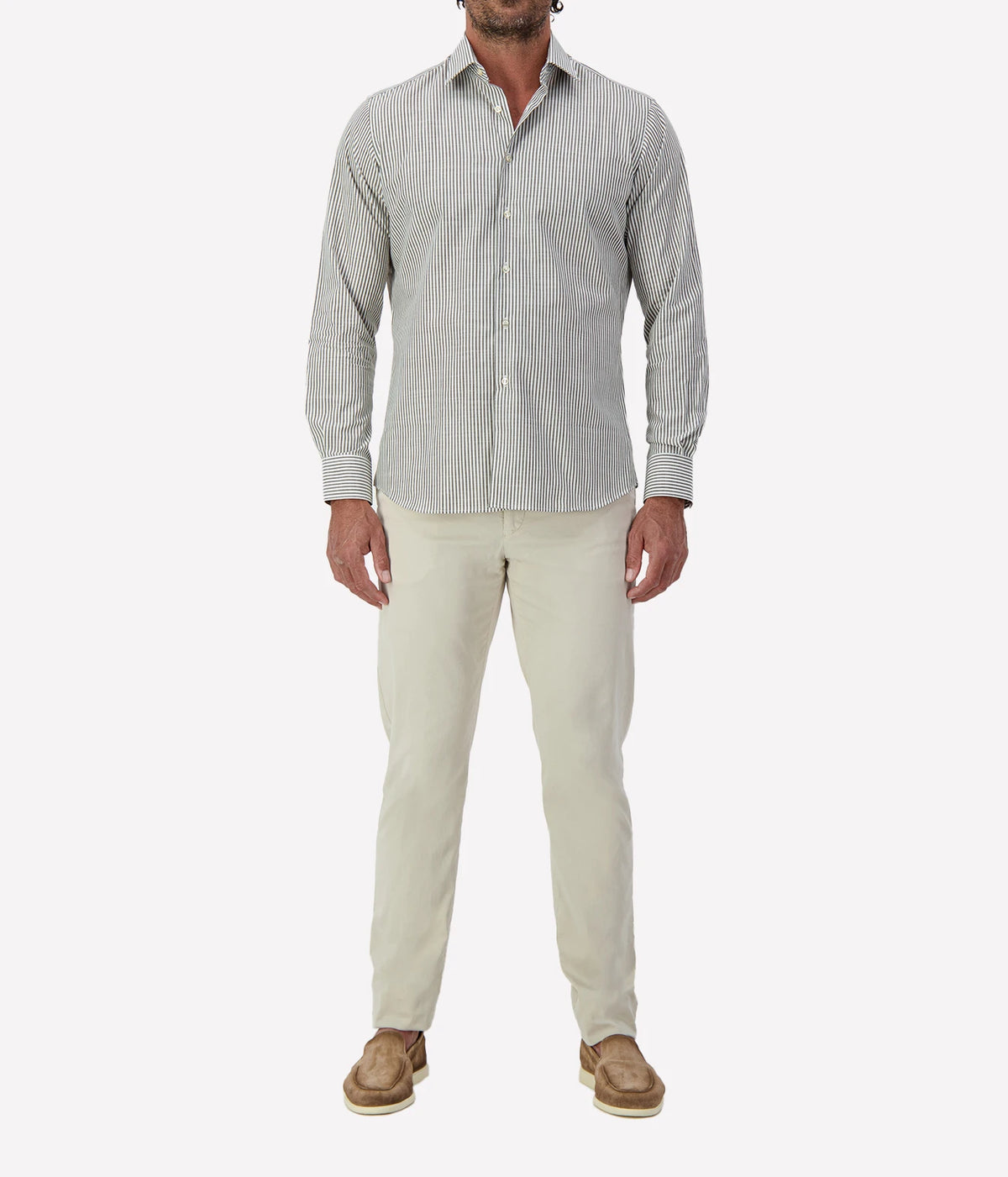 Man wearing Ingram Slim Fit Shirt in Sage & White Stripe with stone chinos and brown suede shoes, full-length front view