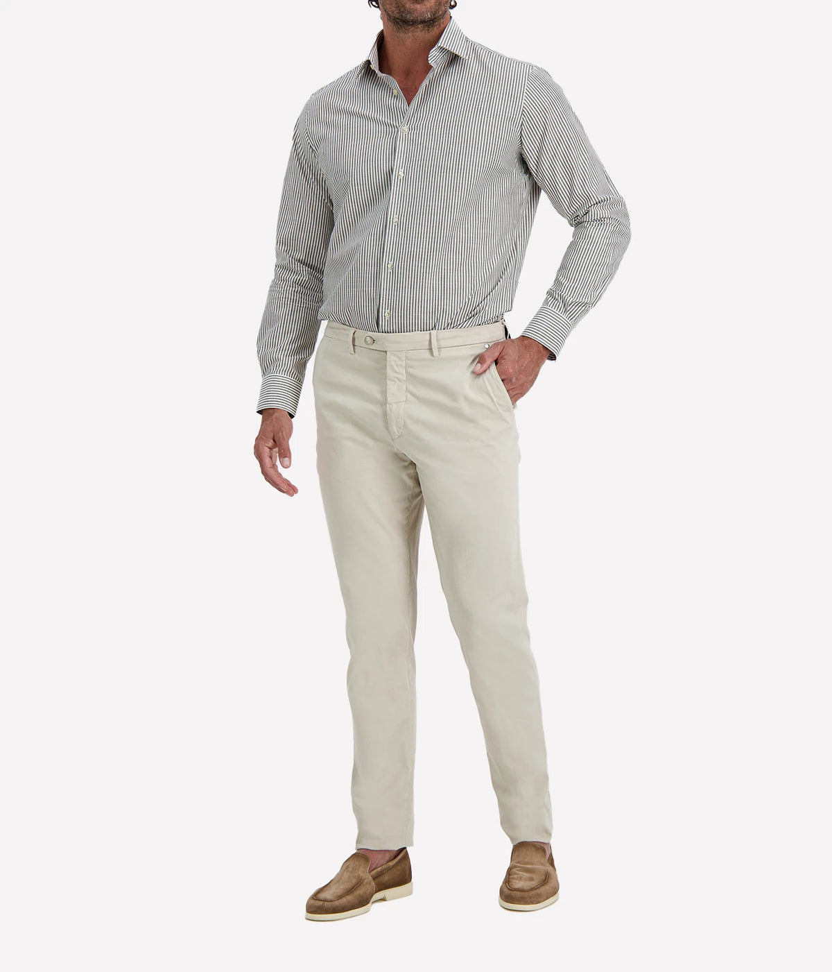 Man wearing Ingram Slim Fit Shirt in Sage & White Stripe with stone chinos and brown suede shoes, front view with hands in pockets