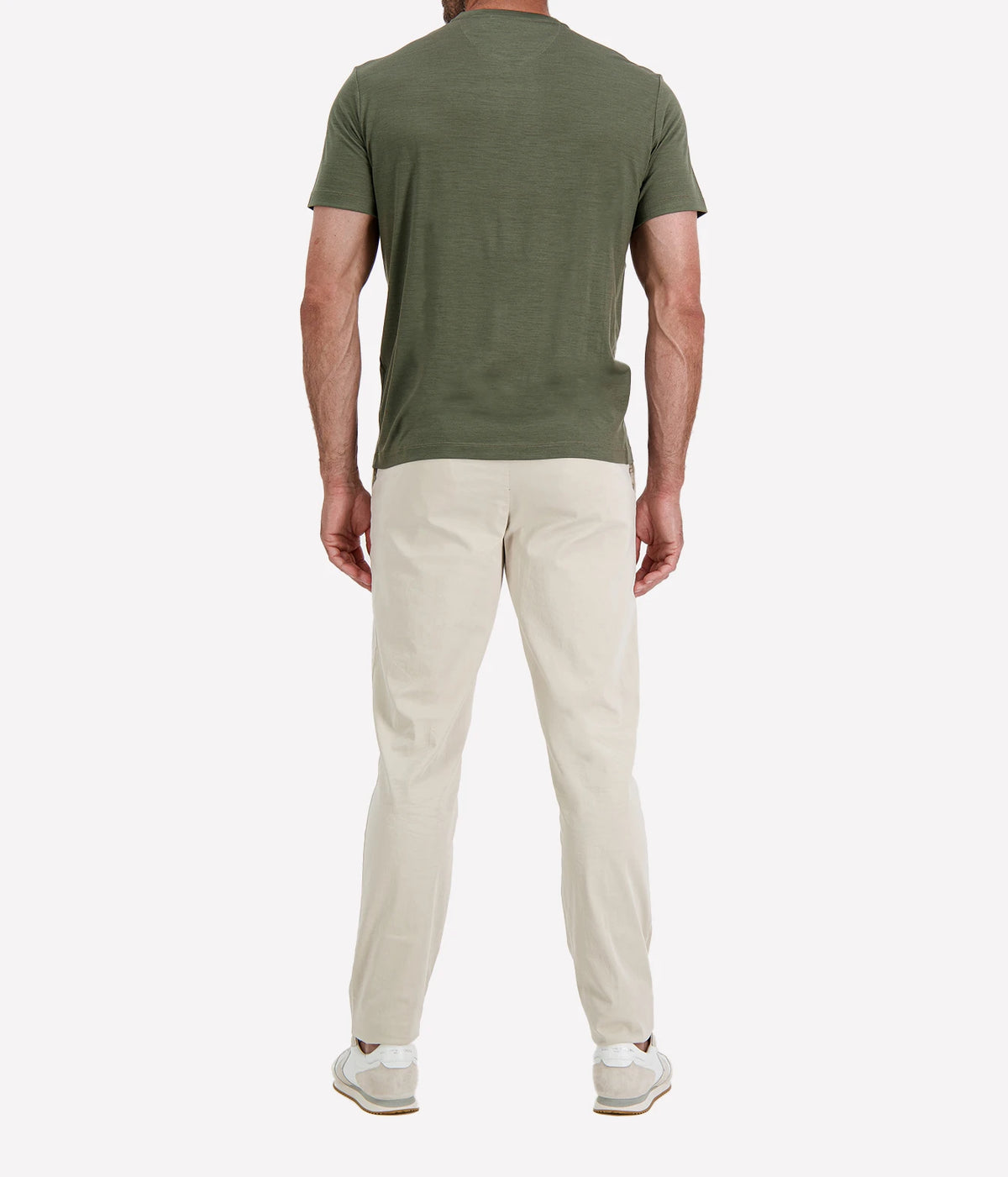 Back view of man wearing Maurizio Baldassari Linate Short Sleeve T-Shirt in Dark Olive with stone trousers and white sneakers