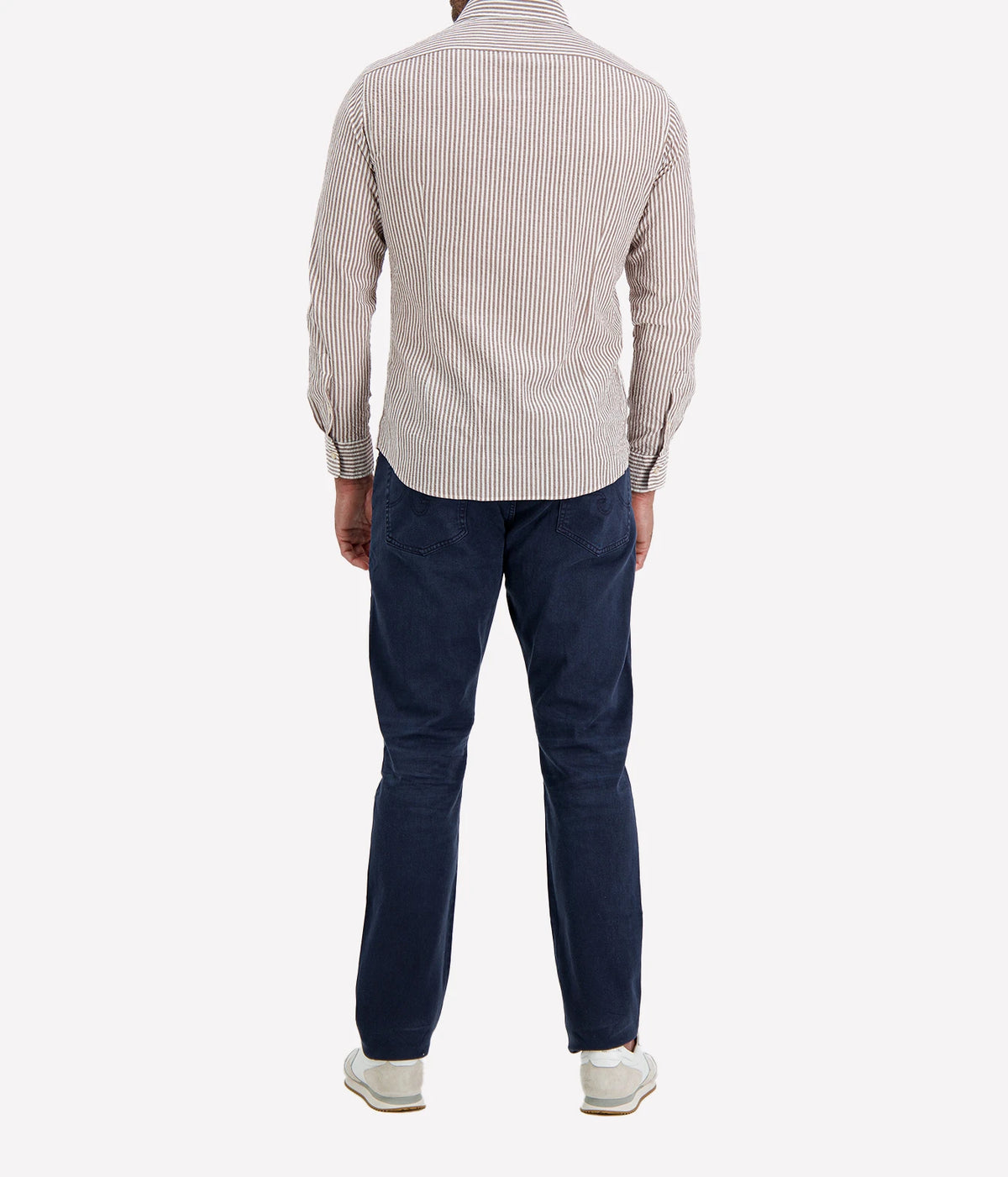 Back view of man wearing Ingram Slim Fit Shirt in Seersucker Brown & White Stripe with indigo jeans and white sneakers