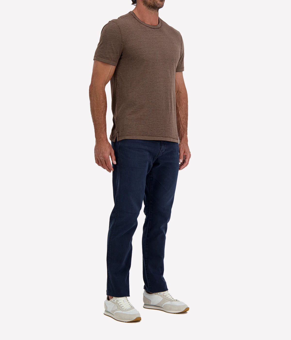 Man wearing John Varvatos Bale Burnout Crewneck Tee in Teakwood with indigo jeans and white sneakers, angled front view