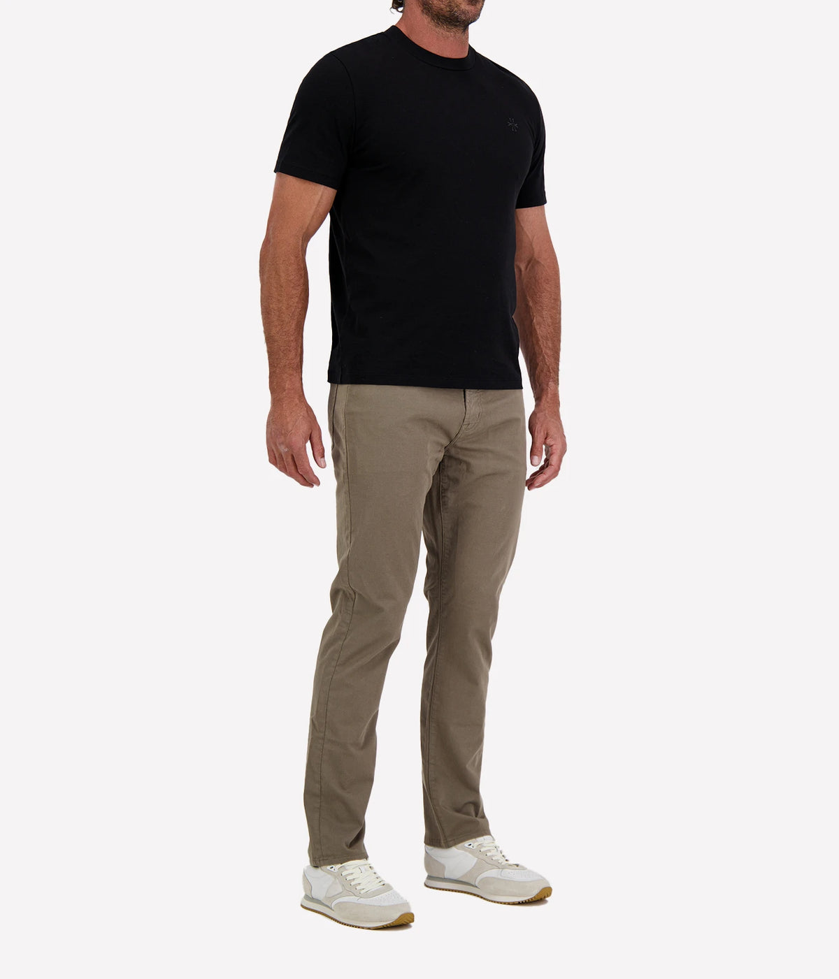 Man wearing Jacob Cohën Girocollo Costina T-Shirt in Black with khaki chinos and white sneakers, angled front view