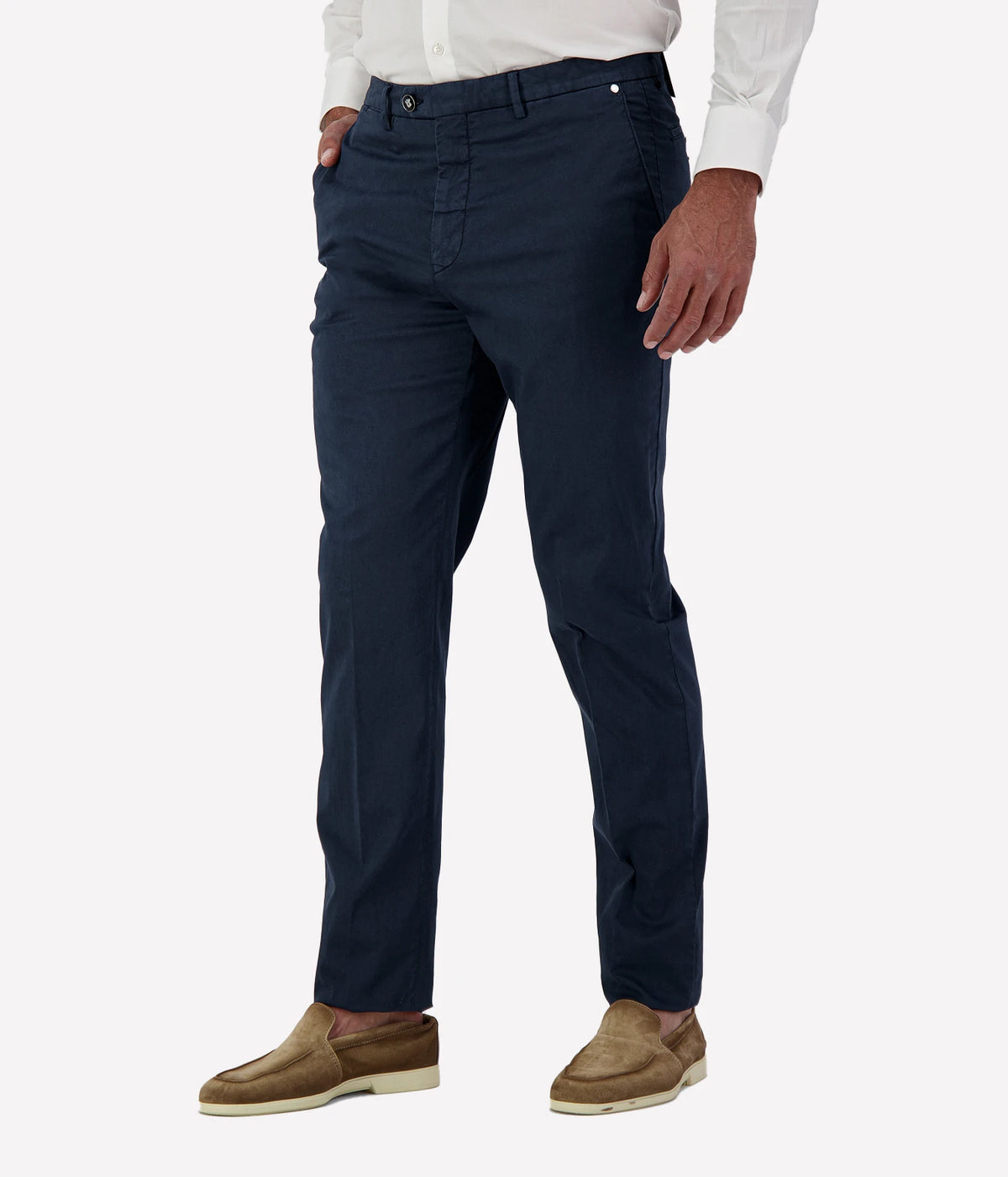Man wearing Marco Pescarolo New York Cotton Silk Trouser in Navy with a white shirt and tan suede shoes, cropped angled front view with hand in pocket