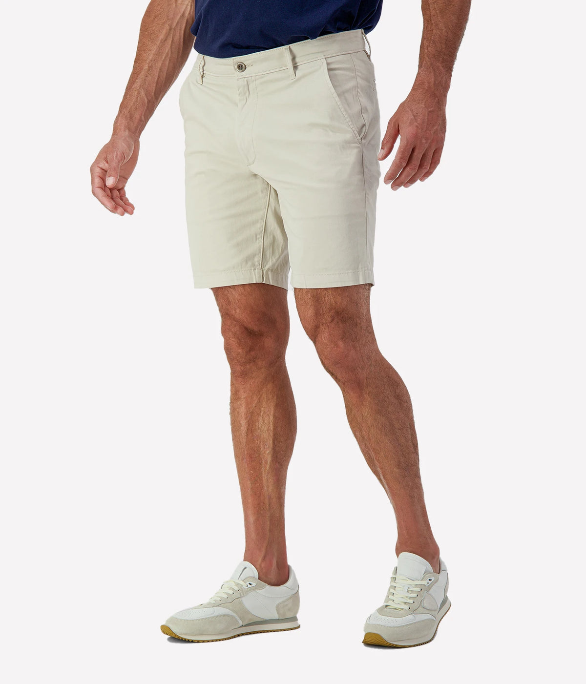 Man wearing AG Wanderer Short in Pumice with a navy T-shirt, cropped angled front view