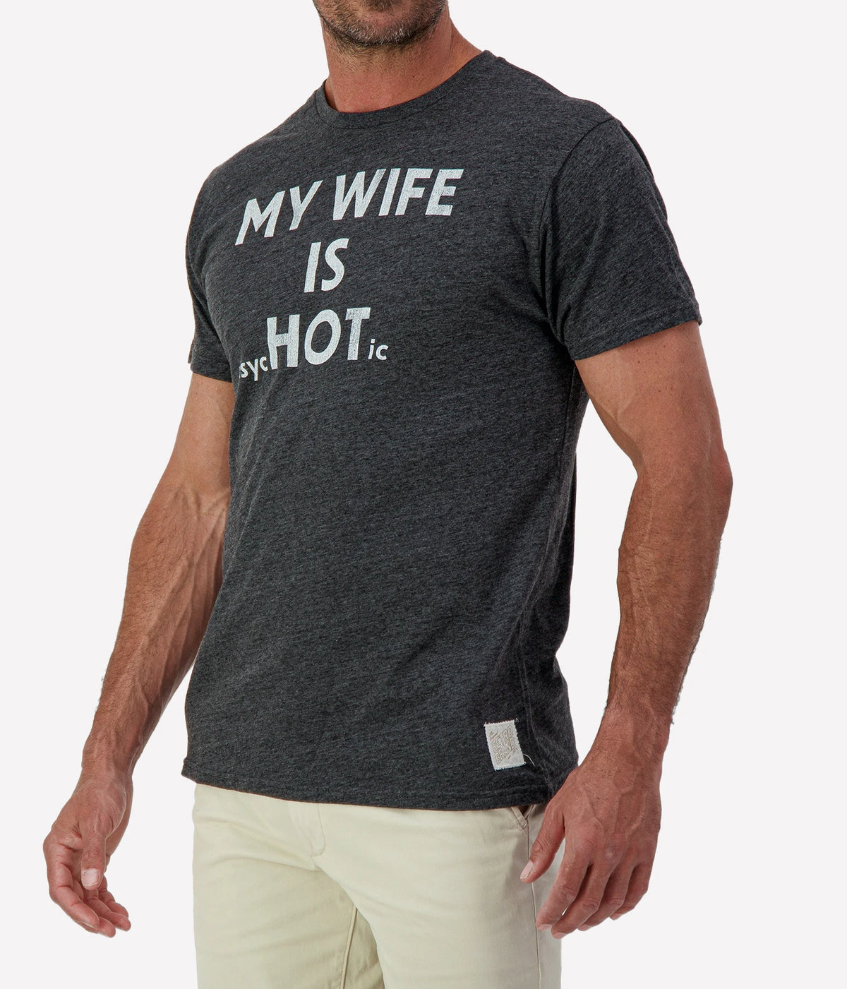 Man wearing Retro Brand My Wife Is Psychotic Tee in Black with stone shorts, cropped angled front view