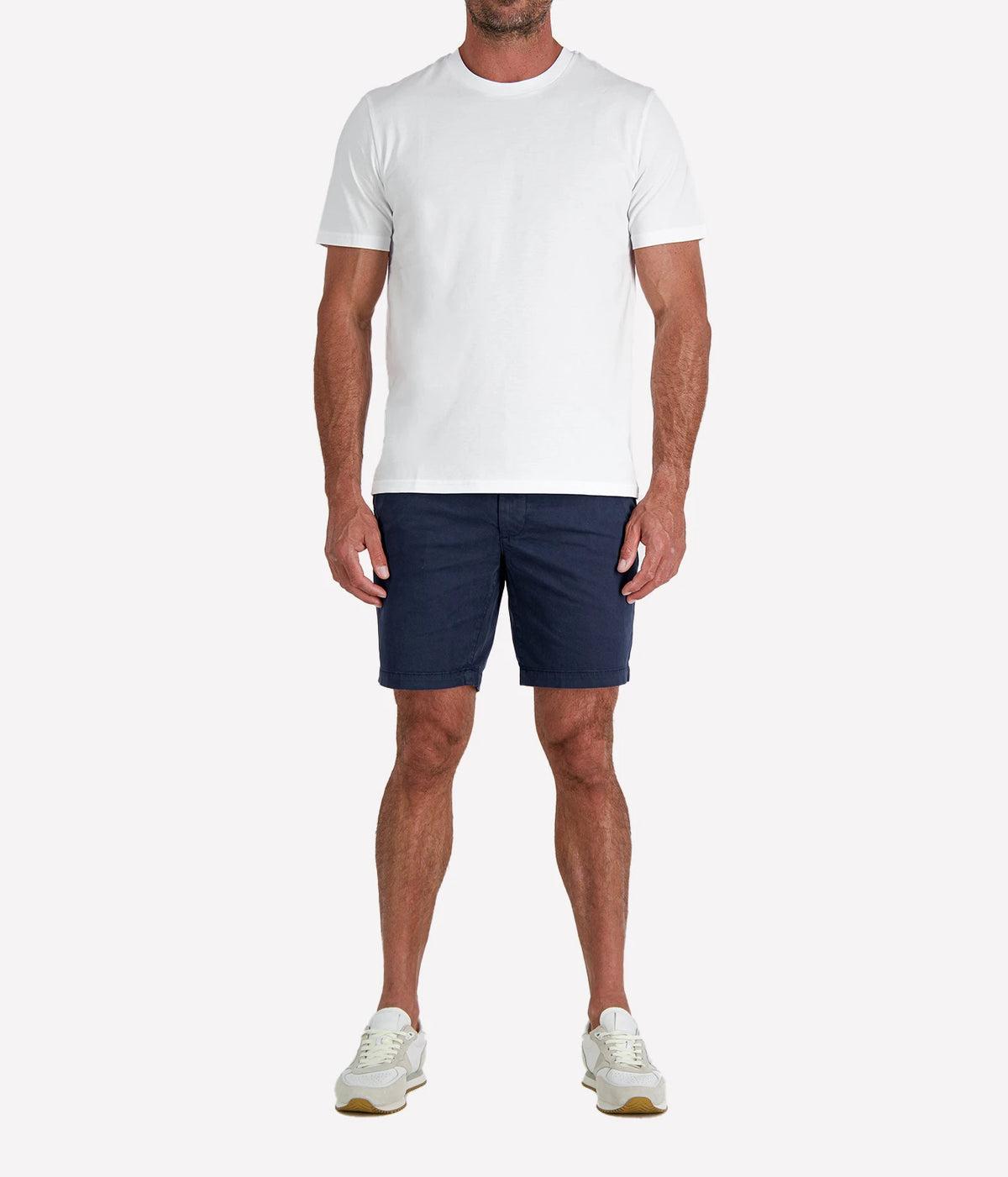 Man wearing Calexico Man Jamie Tee in White with navy shorts and white sneakers, full-length front view