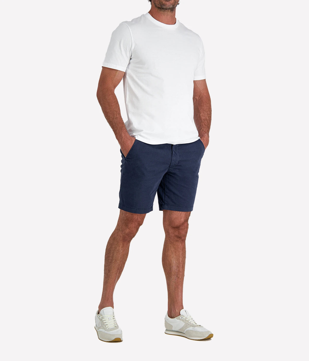 Man wearing Calexico Man Jamie Tee in White with navy shorts and white sneakers, full-length front view with hand in pocket