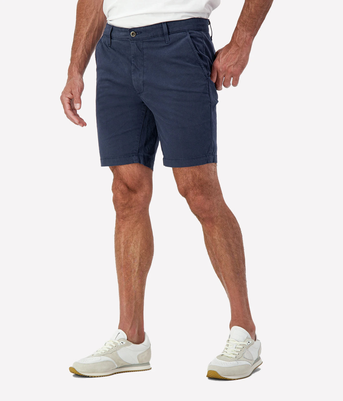 Man wearing AG Wanderer Short in Stormy Night with white sneakers, cropped front view