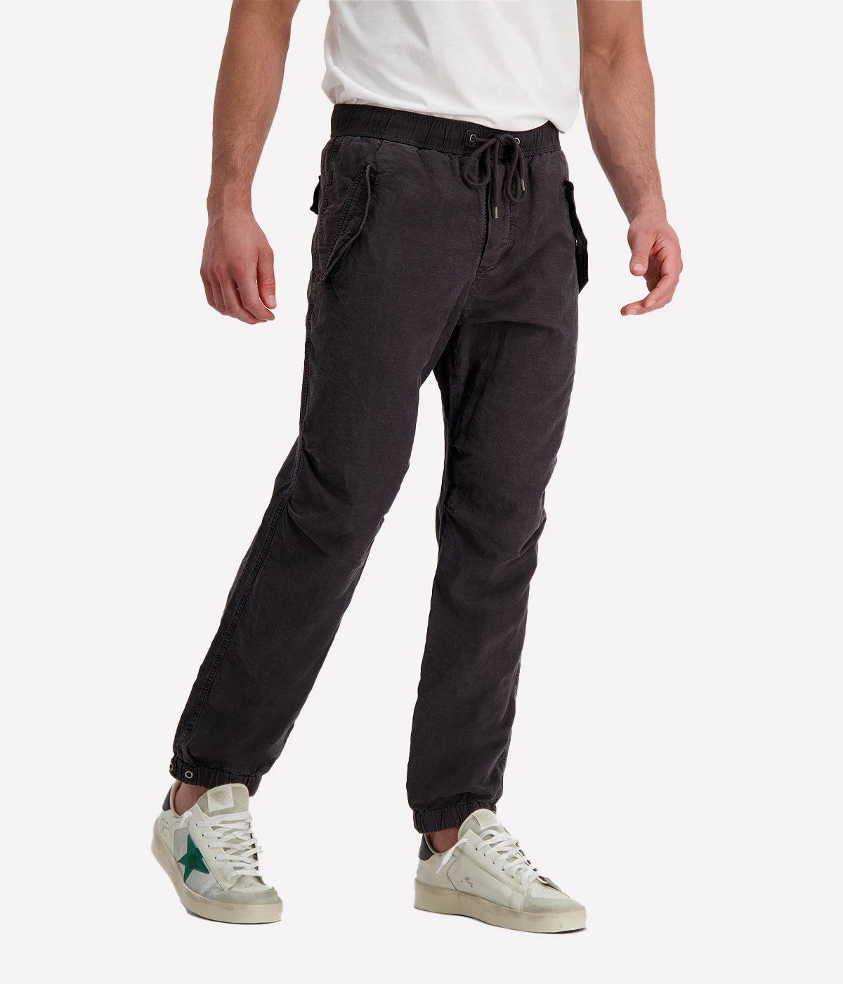Textured cotton hemp flight pants in a relaxed fit, featuring a button fly, cuffed leg opening, knee tuck details, and snap button flap pockets. Crafted from breathable Italian cotton hemp with a unique textured finish.