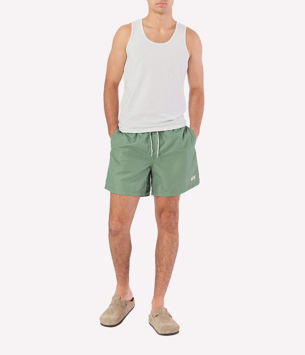 Bather’s geometric swim trunks feature a bold, monochromatic herringbone-inspired pattern, reminiscent of retro ‘60s design. With a 5.5” inseam, reinforced pockets, and a back snap pocket, these quick-dry swim shorts are crafted from 100% recycled polyester for a stylish and sustainable fit.