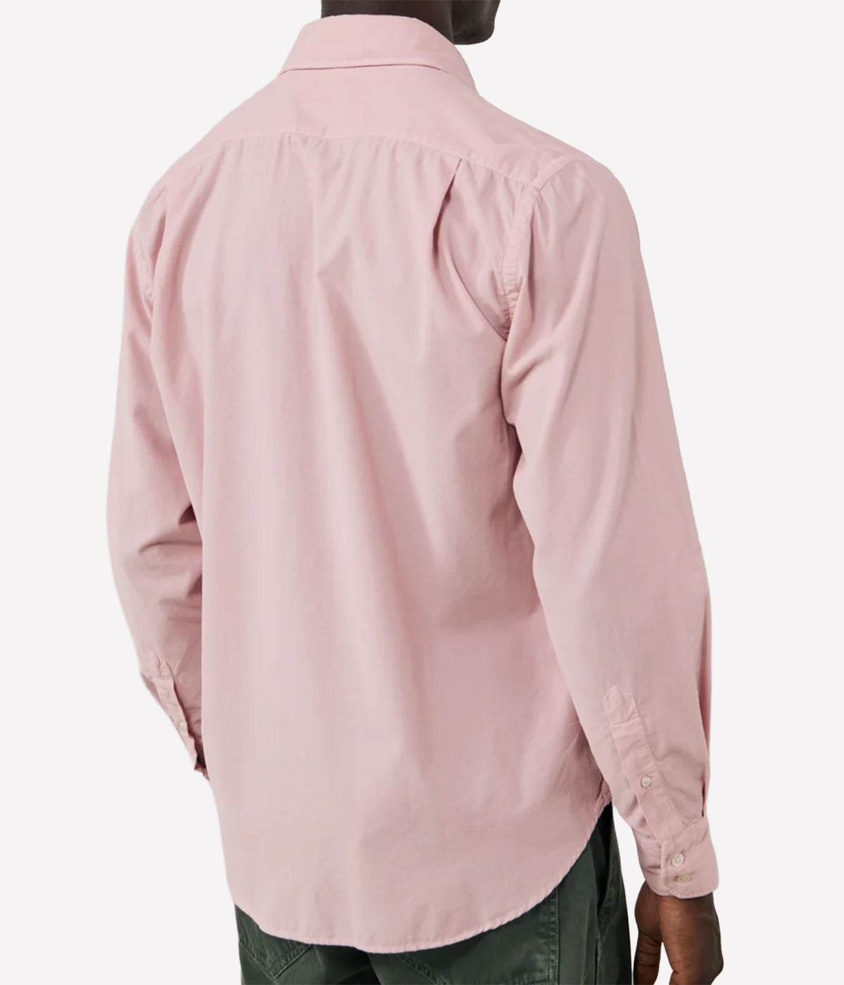 A man wearing a light pink long-sleeve button-down shirt, shown from the back against a plain light grey background.