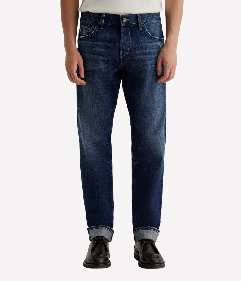 AG Everett slim straight Japanese selvage jeans in dark indigo wash with fading and whiskering, made from non-stretch denim.
