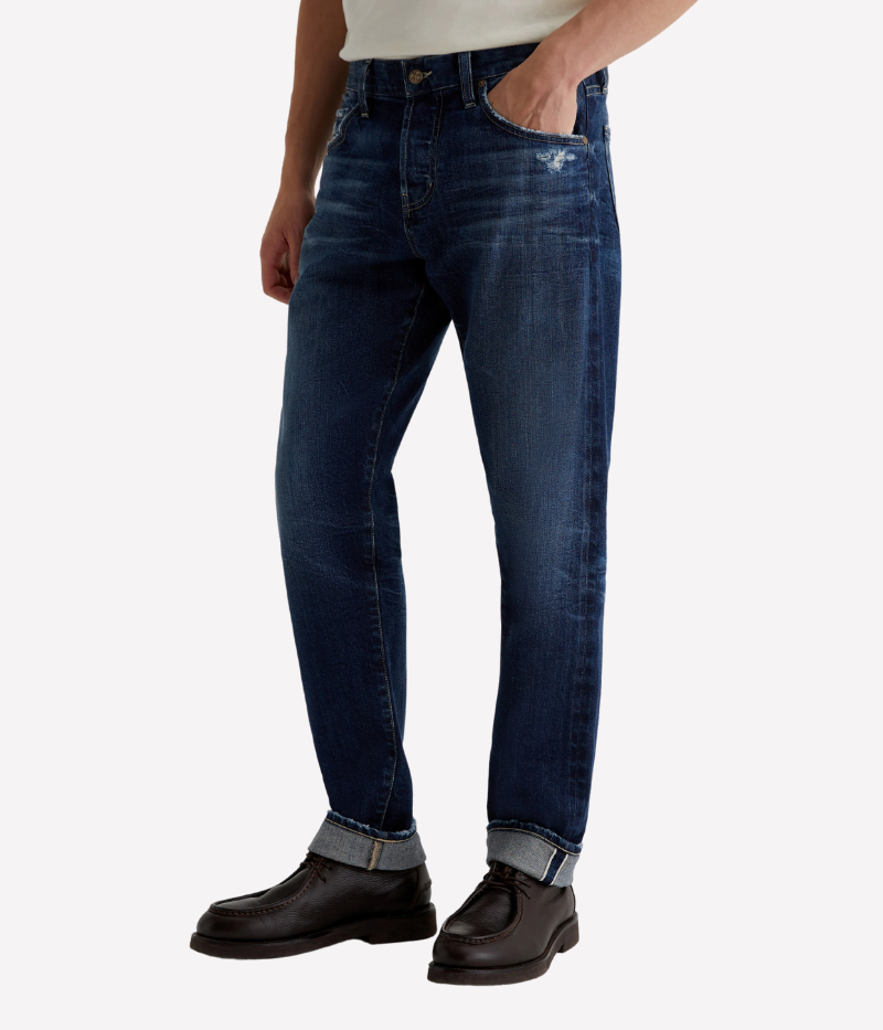 AG Everett slim straight Japanese selvage jeans in dark indigo wash with fading and whiskering, made from non-stretch denim.