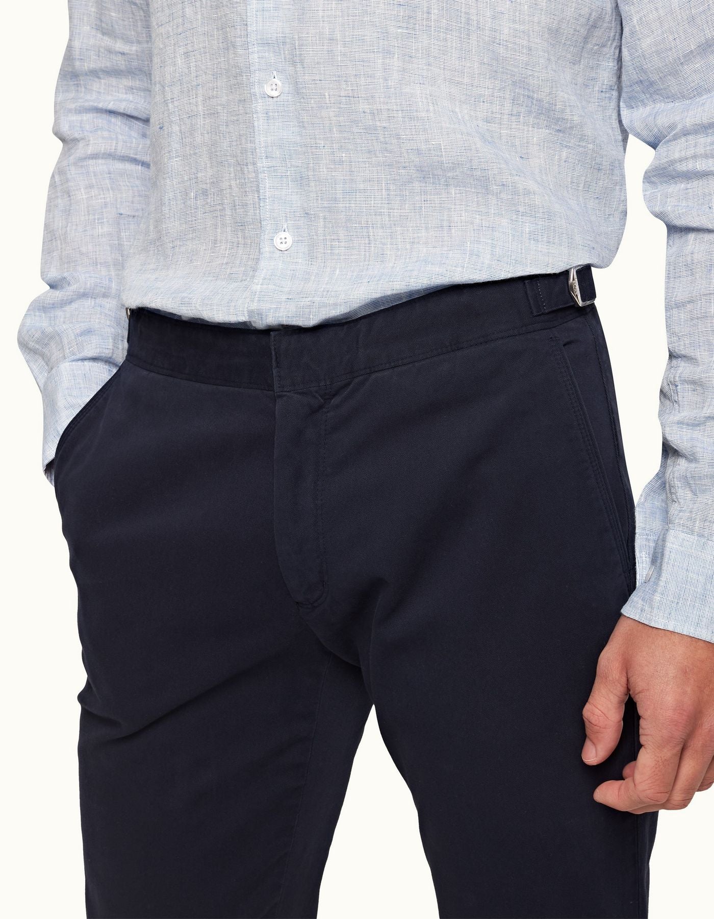Fallon Dark Navy trousers with tailored fit, adjustable side fasteners, and multiple pockets. Made from stretch-cotton twill for comfort and versatility, perfect for both casual and dressy looks.
