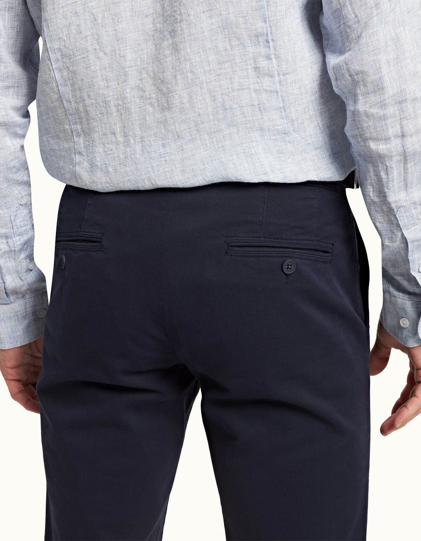 Fallon Dark Navy trousers with tailored fit, adjustable side fasteners, and multiple pockets. Made from stretch-cotton twill for comfort and versatility, perfect for both casual and dressy looks.