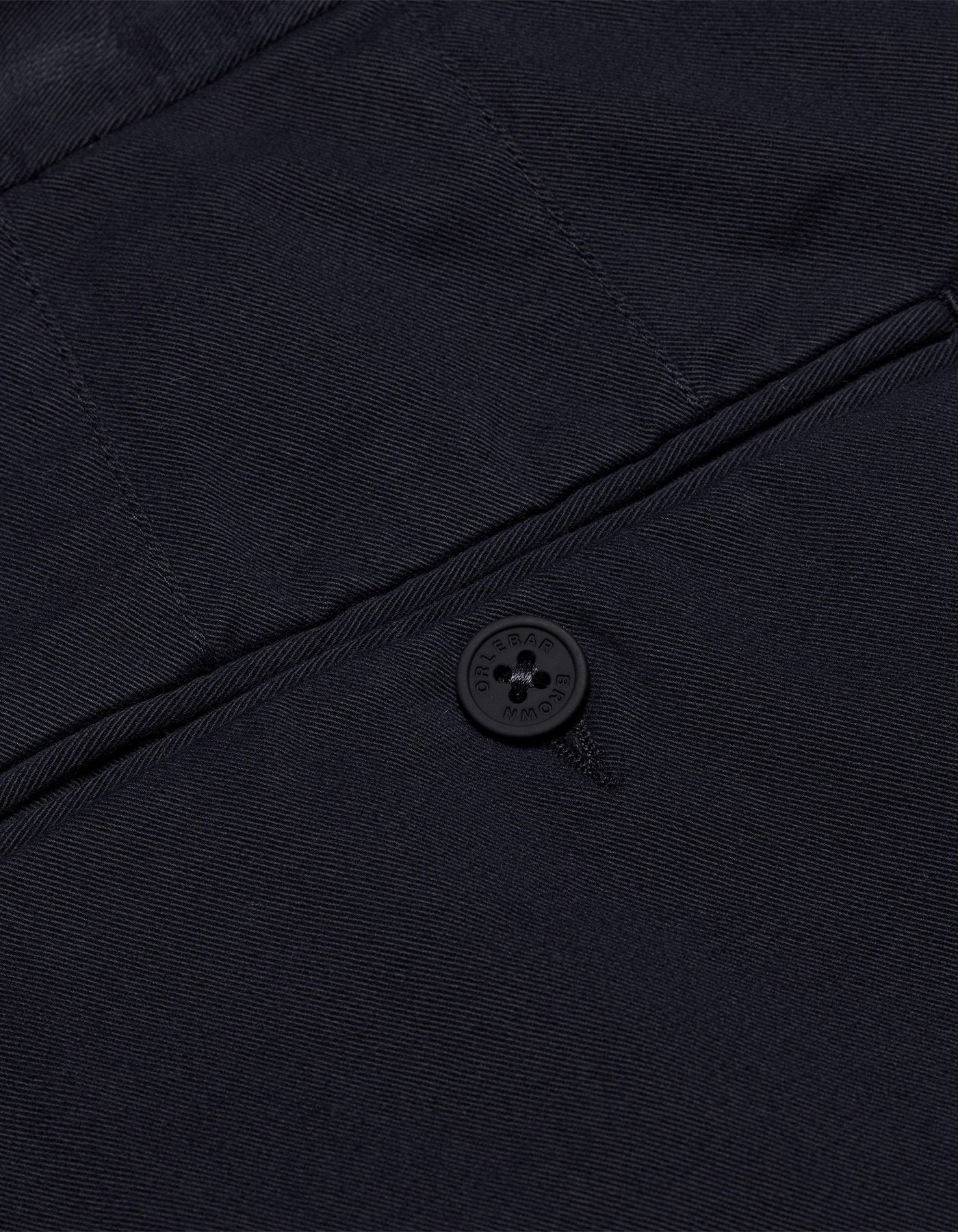 Fallon Dark Navy trousers with tailored fit, adjustable side fasteners, and multiple pockets. Made from stretch-cotton twill for comfort and versatility, perfect for both casual and dressy looks.