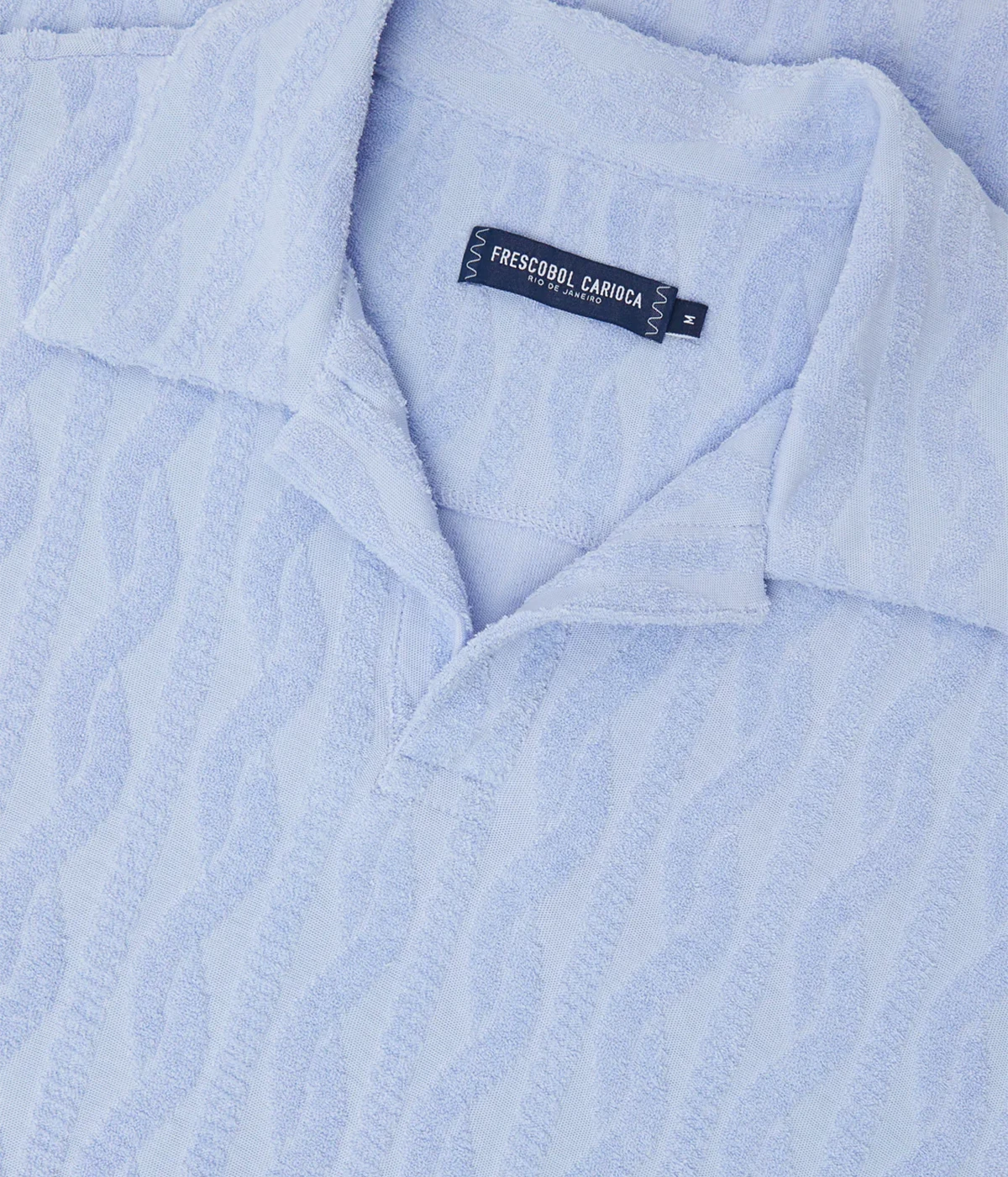 Faustino polo in organic Terry cotton with jacquard pattern, open camp collar, relaxed fit, and side slits. Buttonless collar for a modern twist.
