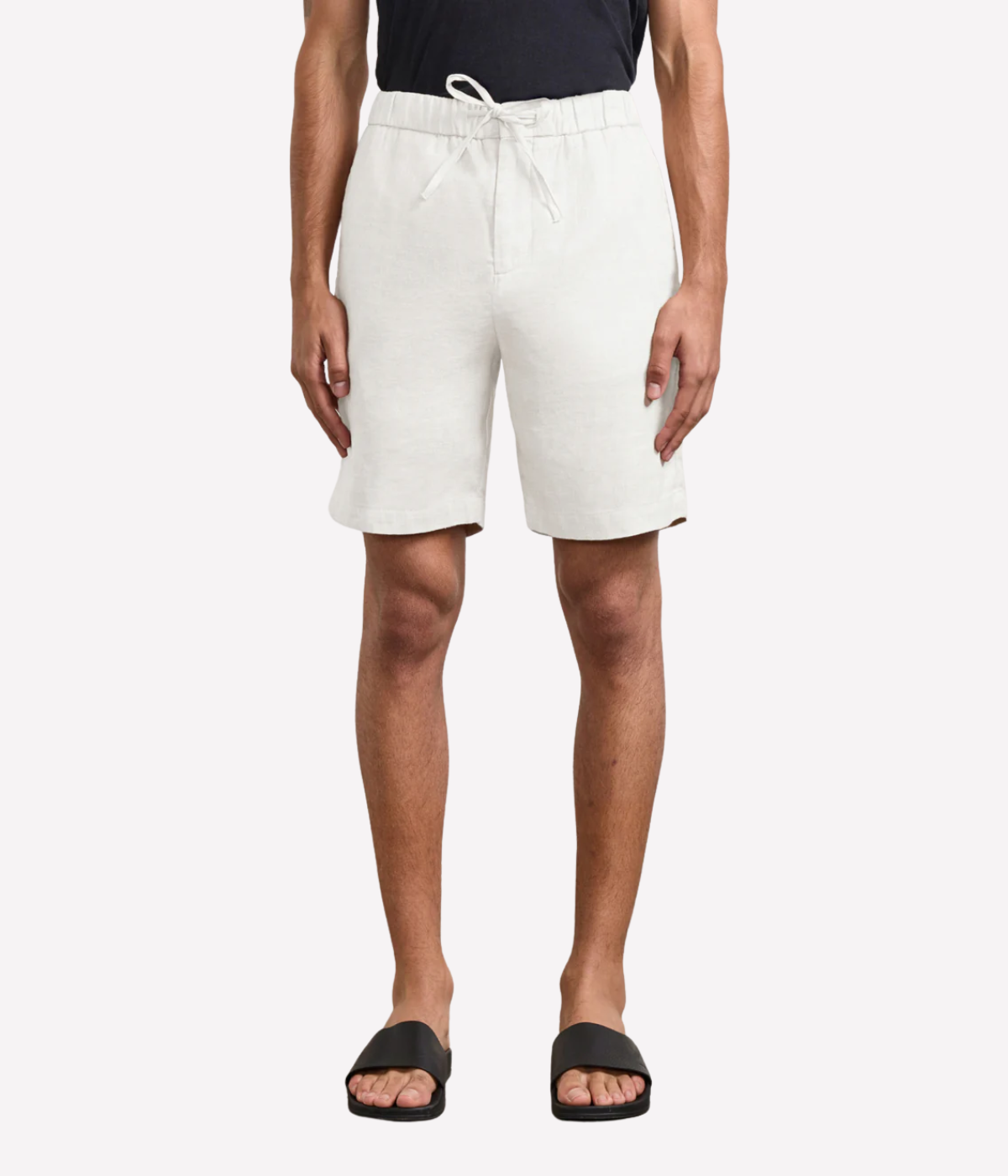 Person wearing white shorts on a white background