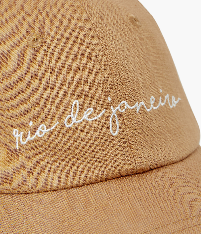 almond linen baseball cap with "rio de janeiro" embroidered on the front, featuring an adjustable back strap and breathable summer-ready fabric.