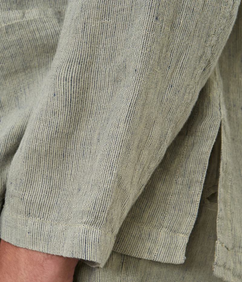 Striped linen shirt jacket with a single-breasted design, small lapels, and three patch pockets, made in Italy.
