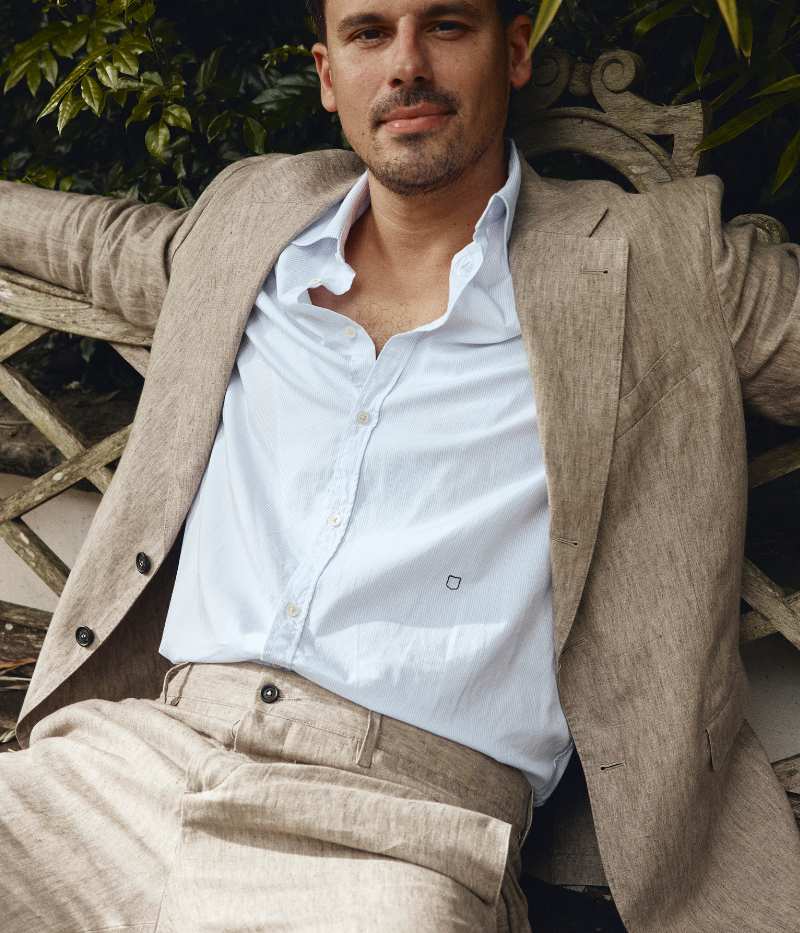 Regular-fit cotton shirt with a pointed collar, soft front placket, cotton voile inner bib, and custom badge embroidery. Made in Italy.