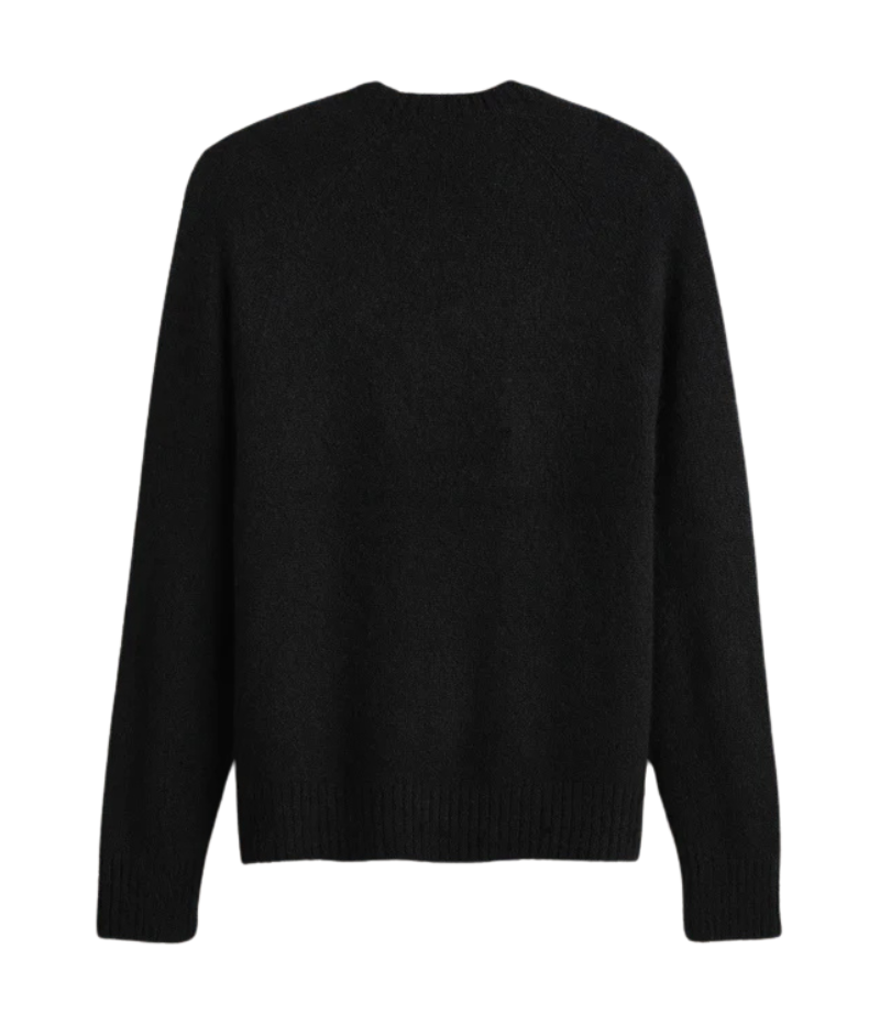 A lightweight, true black cashmere crewneck sweater featuring ribbed detailing at the neckline, cuffs, and hem for a classic and polished appearance.