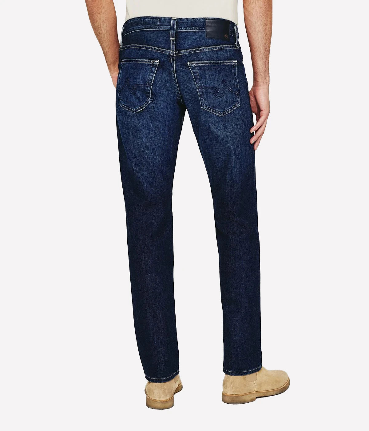 AG Graduate slim straight jeans for men in a medium-dark wash, featuring a slim mid-rise waist and relaxed fit through the hip to the knee. Tapered leg opening with Flex 360° Denim for added comfort and stretch