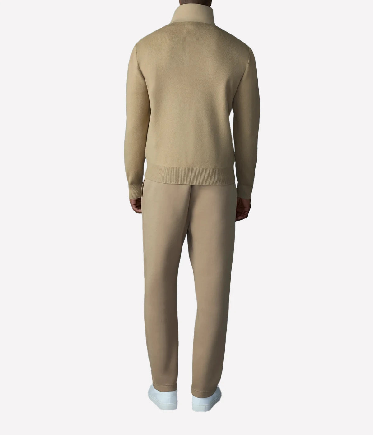 Hybrid down vest with stretch-knit body, ribbed trims, zip pockets, and subtle logo detail.