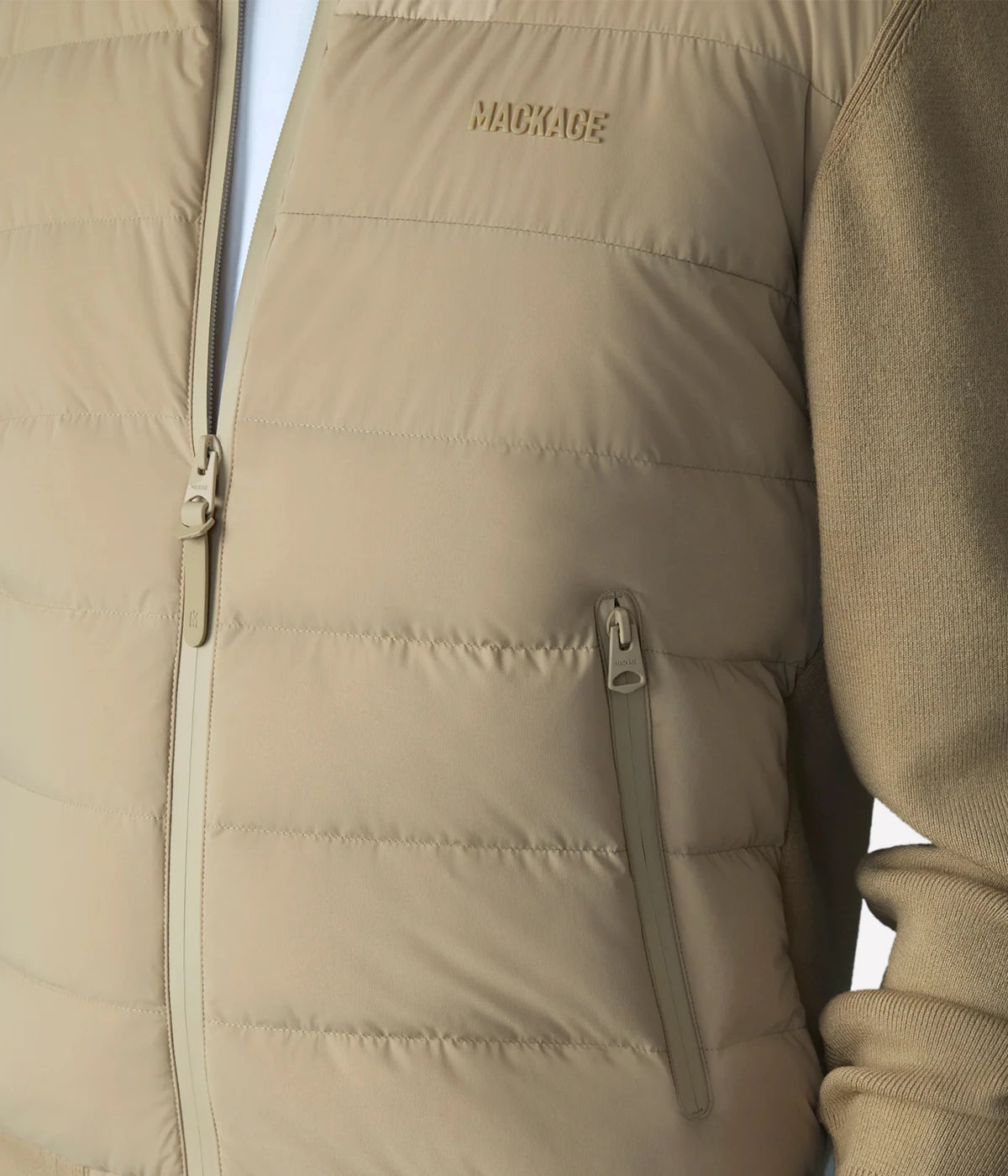 Hybrid down vest with stretch-knit body, ribbed trims, zip pockets, and subtle logo detail.