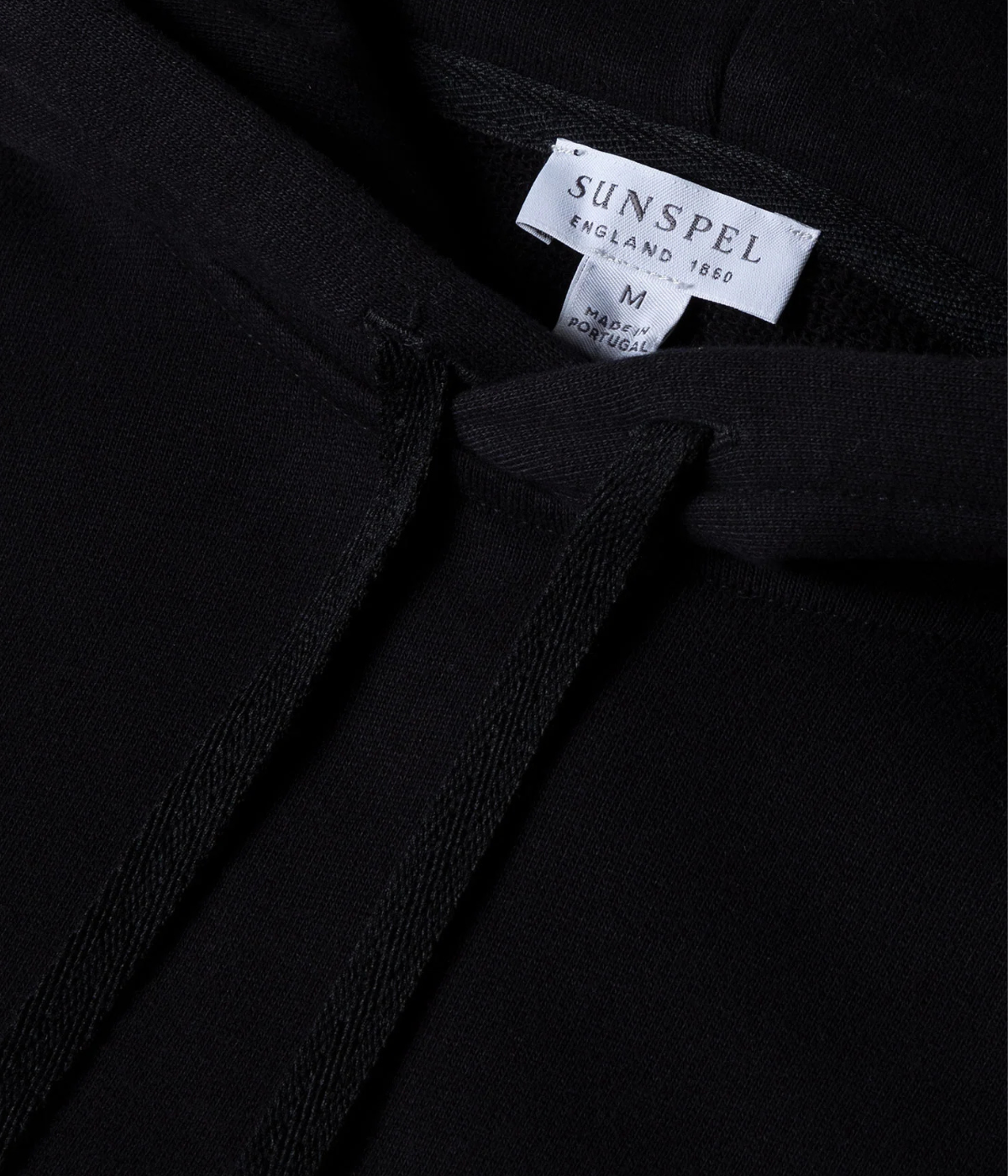 Men’s black loopback hoodie with double-layered hood, ribbed trims, and patch pocket—crafted from breathable cotton for year-round comfort.