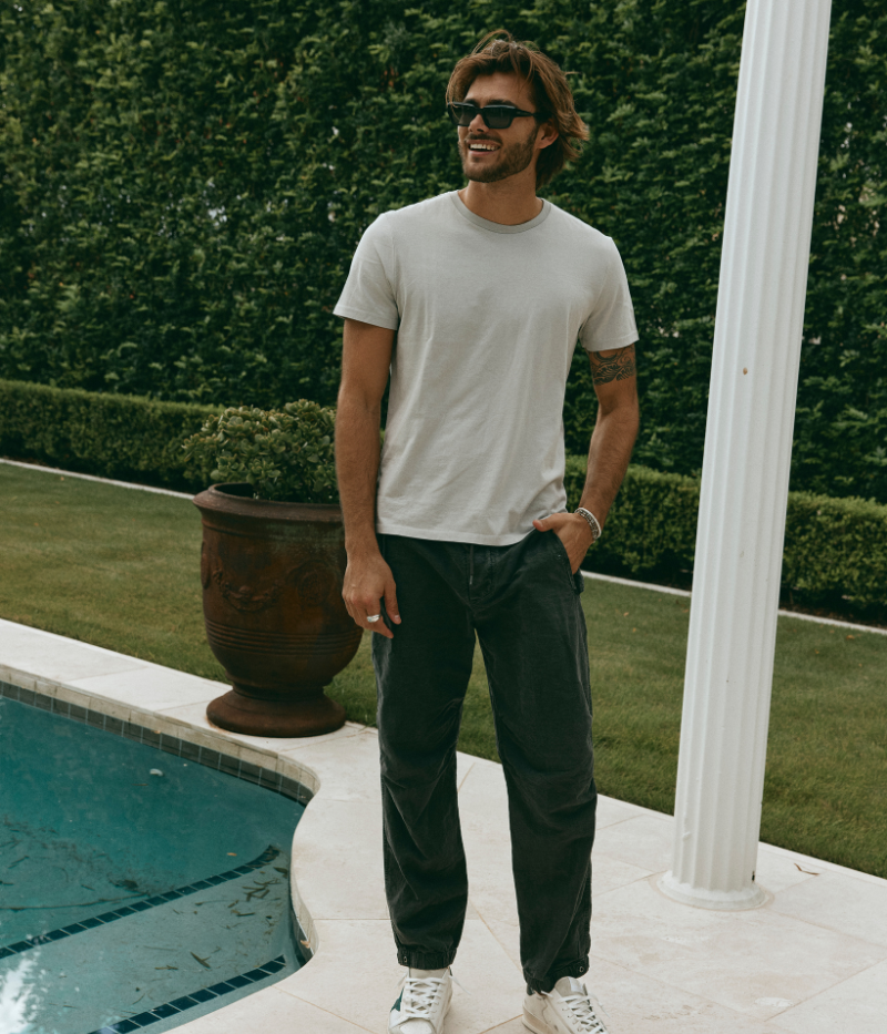 Textured cotton hemp flight pants in a relaxed fit, featuring a button fly, cuffed leg opening, knee tuck details, and snap button flap pockets. Crafted from breathable Italian cotton hemp with a unique textured finish.