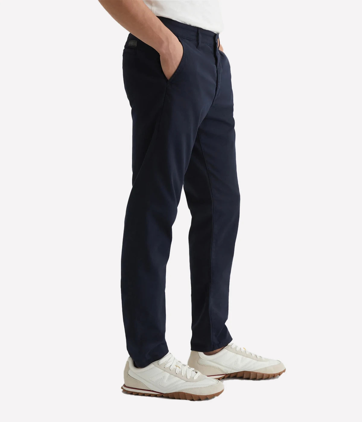 The Jamison Skinny Trouser in navy is captured from the side, showing off its sleek skinny fit and tapered leg openings. Made from Sorrento Stretch Twill, this stylish trouser offers a sharp, modern silhouette that contours the body for a refined look. Perfect for elevating any casual or smart ensemble.