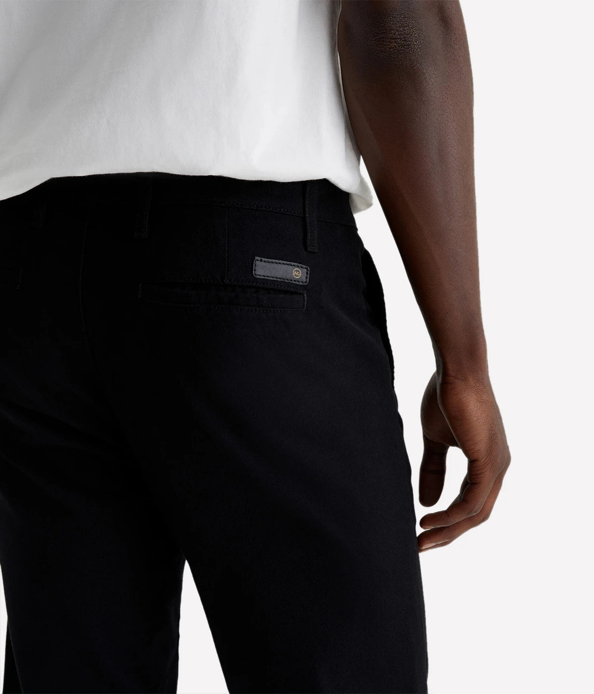 A close-up shot of the Jamison Skinny Trouser in black, showing the soft texture of the Sueded Brushed Moleskin fabric. The fabric’s sueded finish adds a refined touch to the trousers, while the tailored waist and slim fit give it a modern, sharp profile.